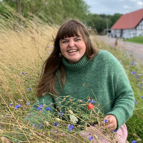 Billede af Skaberglæde, der sidder i en blomstereng.