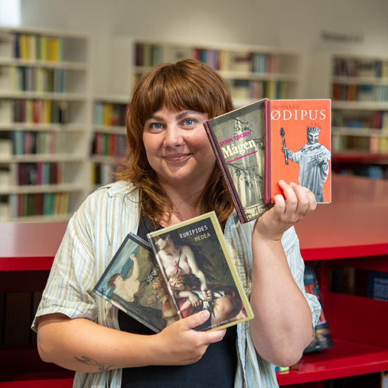 Billede af biblioteksformidler med fire bøger